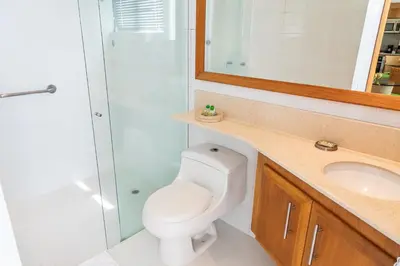a bathroom with a toilet and a sink and a shower at Hotel Irotama del Mar in Santa Marta