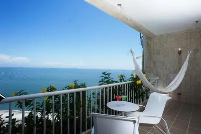 a balcony with a table and chairs and the ocean at Hotel Irotama del Mar in Santa Marta