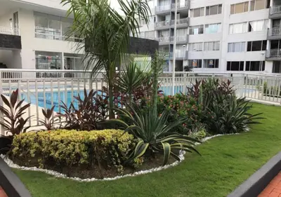 a resort yard with a swimming pool and plants at Apartamento Vacacional En La Zona Norte De Barranquilla in Barranquilla