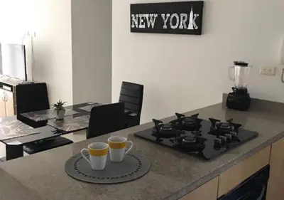 a kitchen with a stove and two cups of coffee at Apartamento Vacacional En La Zona Norte De Barranquilla in Barranquilla
