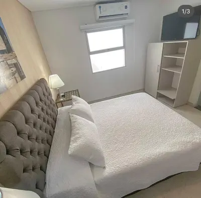 a bedroom with a large bed and a window at Hotel Casa Nico in Barranquilla