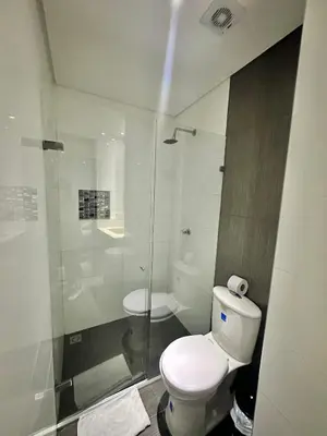 a bathroom with a toilet and a glass shower at Hotel La Esperanza in Cartagena de Indias
