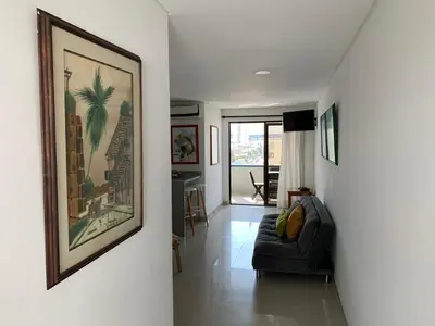 a living room with a couch and a picture on the wall at Portofino Cartagena Bocagrande By ICDI in Cartagena de Indias