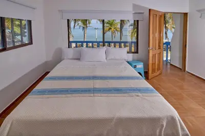 a bedroom with a bed with a view of the ocean at Cabaña El Refugio in San Antero