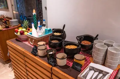 a counter with bowls of food and buckets of food at GHL Arsenal Hotel in Cartagena de Indias