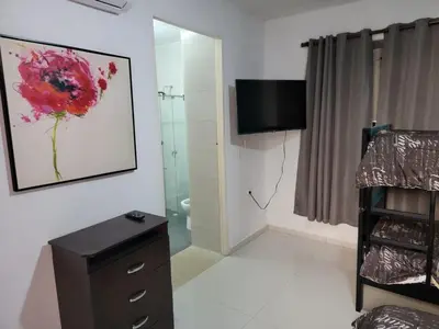a bathroom with a shower and a television on the wall at Casa Evelyn in Cartagena de Indias