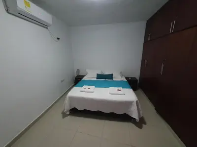 a bedroom with a bed with two towels on it at Casa Evelyn in Cartagena de Indias