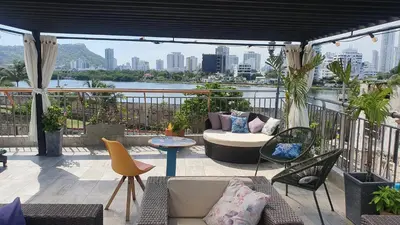 a patio with a couch and chairs on a balcony at Casa Evelyn in Cartagena de Indias