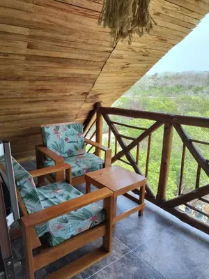 two chairs and a table on a porch at Hotel Calamari Baru in Playa Blanca