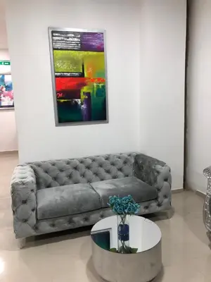 a living room with a couch and a table at Hotel Platinum Barranquilla in Barranquilla