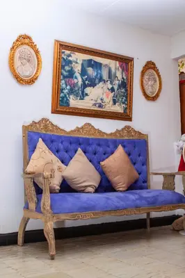 a blue couch in a room with a painting on the wall at Balcones de Venecia in Cartagena de Indias