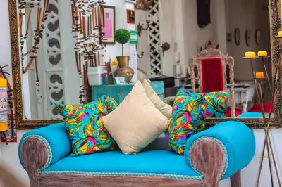 a blue couch with colorful pillows on top of it at Balcones de Venecia in Cartagena de Indias