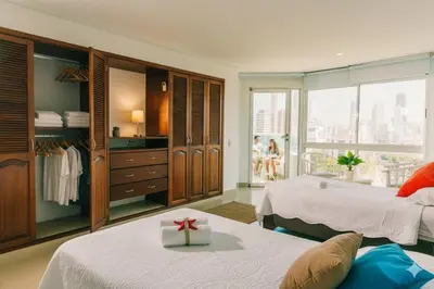 a bedroom with two beds and a gift in a room at Torres del Lago B-2 in Cartagena de Indias
