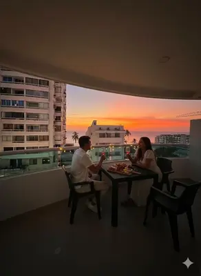 a man and a woman sitting at a table in a balcony at Torres del Lago B-2 in Cartagena de Indias