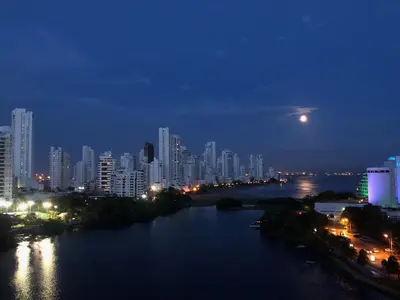 a city at night with a river and buildings at Torres del Lago B-2 in Cartagena de Indias