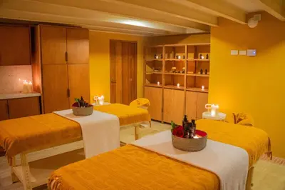 a room with four beds and yellow walls at Casa Carolina Luxury Wellness Hotel in Cartagena de Indias