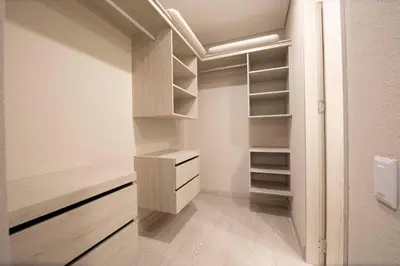a walk in closet with white walls and wooden shelves at Cielo Mar Regatta - LivinColombia in Cartagena de Indias