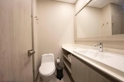 a bathroom with a toilet and a sink and a mirror at Cielo Mar Regatta - LivinColombia in Cartagena de Indias