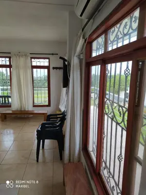 a living room with a chair and a window at Hotel Brisas del Mar San Antero in San Antero
