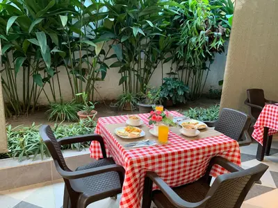 a table with a red and white checkered table cloth at Hotel Boutique M in Barranquilla