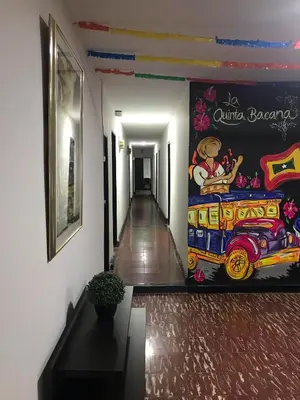 a hallway with a painting of a train on the wall at La Quinta Bacana in Barranquilla