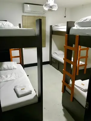 a room with three bunk beds and a ladder at La Quinta Bacana in Barranquilla