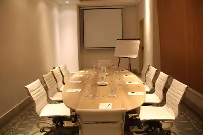 a conference room with a long table and white chairs at Radisson Cartagena Ocean Pavillion Hotel in Cartagena de Indias