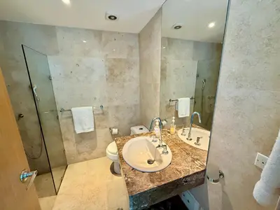 a bathroom with a sink and a toilet and a shower at Bello apartamento dentro del Hotel Radisson Ocean Pavillion in Cartagena de Indias