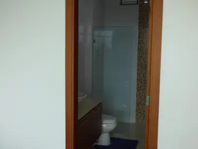 a bathroom with a toilet and a glass shower at Costa Azul Suites 403 in Santa Marta