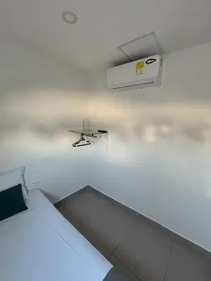 a bedroom with a bed and a air conditioner on the wall at Casa Prado 59 in Barranquilla