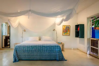 a bedroom with a bed with a canopy at Hotel Playa Manglares Isla Baru in Baru