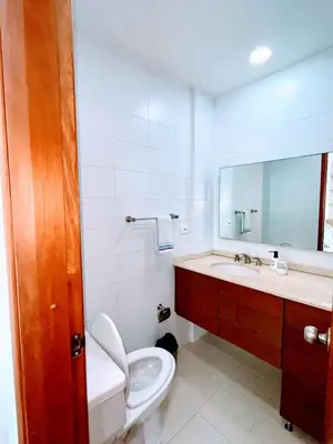 a bathroom with a toilet and a sink and a mirror at Apartamento en cartagena Boquilla vista al mar dos Hab in Cartagena de Indias