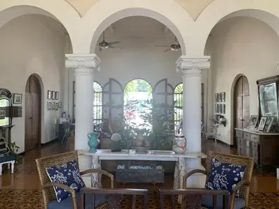 a living room with white columns and a table and chairs at Casa Bustamante Hotel Boutique in Cartagena de Indias