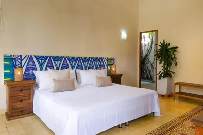 a bedroom with a large white bed with white sheets at Casa Bustamante Hotel Boutique in Cartagena de Indias