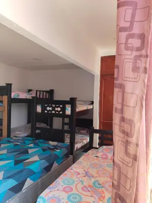 a room with two bunk beds and a bed at LA MEDELLIN HOSTAL in Cartagena de Indias