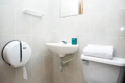 a bathroom with a sink and a toilet and a mirror at Hotel Puerto Colombia in Puerto Colombia