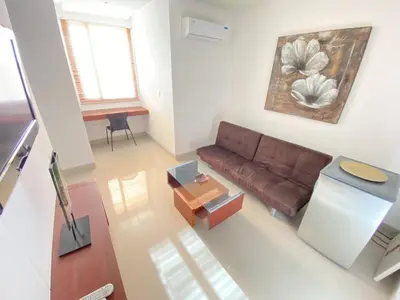 a living room with a couch and a table at Atlantic Garden Hotel in Barranquilla