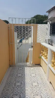 a room with a gate and a tile floor at Casa Francia in Cartagena de Indias