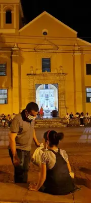 a man and a woman sitting in front of a building at Casa Francia in Cartagena de Indias
