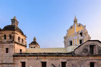 an old building with a dome on top of it at Casa San Pedro - Exclusive 3BR Colonial Apt in Centro Historico by Huespedia in Cartagena de Indias