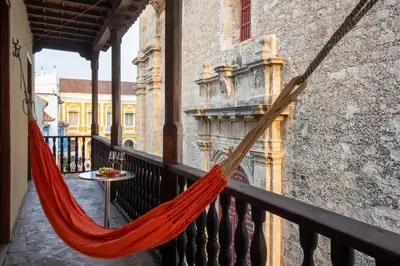 a hammock on a balcony in a building at Casa San Pedro - Exclusive 3BR Colonial Apt in Centro Historico by Huespedia in Cartagena de Indias