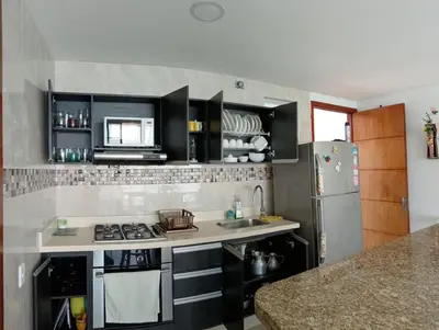 a kitchen with a stove and a refrigerator at palmetto frente al mar in Cartagena de Indias