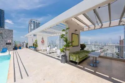 a rooftop patio with a couch and a pool on a building at Hampton by Hilton Cartagena in Cartagena de Indias
