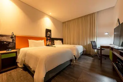a hotel room with two beds and a television at Hampton by Hilton Cartagena in Cartagena de Indias