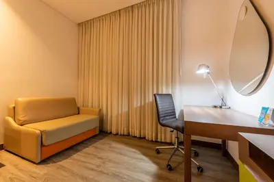 a room with a desk and a chair and a table at Hampton by Hilton Cartagena in Cartagena de Indias