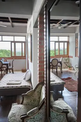 a living room with couches and tables and windows at Casa Caracola in Tubará
