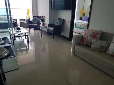 a living room with a couch and a table at Encantador apartamento frente a la playa in Cartagena de Indias