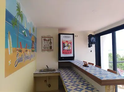 a room with a table and a sign on the wall at Casa en Santa Veronica Atlantico in Santa Veronica