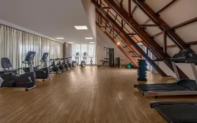 a gym with treadmills and cardio equipment in a room at Grand Sirenis Cartagena in Cartagena de Indias