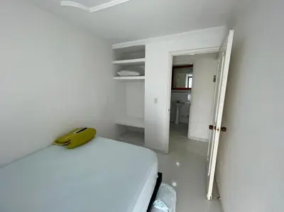 a white room with a bed with a yellow phone on it at Vista Al Mar, Aire Acondicionado en Todo el Apto, Wi-Fi, Parqueadero in Cartagena de Indias